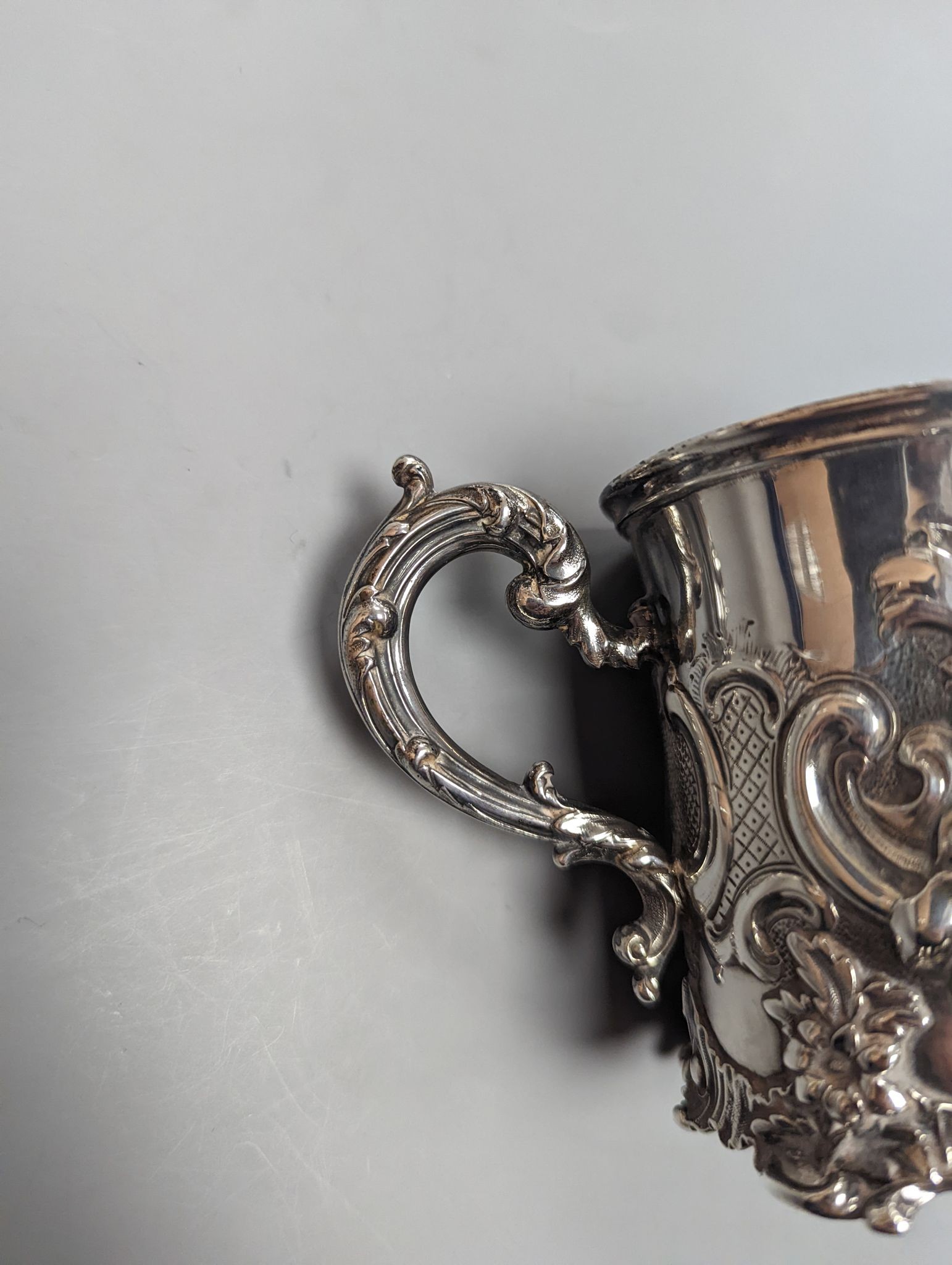 A Victorian embossed silver christening mug, decorated with roses amid scrolls, The Barnards, London, 1843, 9cm, 6.5oz.